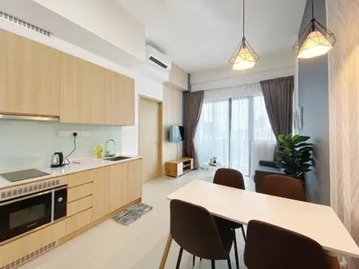 a kitchen and living room with a table and chairs at The Colony Infinitum By Happy Stay in Kuala Lumpur