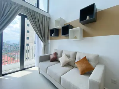 a living room with a couch and a large window at The Colony Infinitum By Happy Stay in Kuala Lumpur