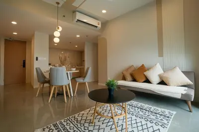 a living room with a couch and a table at Elegant 1BR in OOAK Suites, Mont Kiara KL - Walk to Malls & Dining in Kuala Lumpur