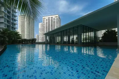 a large swimming pool in front of a building at Elegant 1BR in OOAK Suites, Mont Kiara KL - Walk to Malls & Dining in Kuala Lumpur