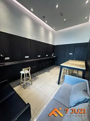 a room with a table and a couch and a table and chairs at Premium&Cozy Studio small cinema KLCC InfinityPool in Kuala Lumpur