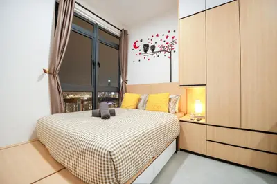 a bedroom with a bed with a checkered blanket at Neu Suites By Cozy Unit L30RA 2-3PAX near KLCC & Jelatek LRT in Kuala Lumpur