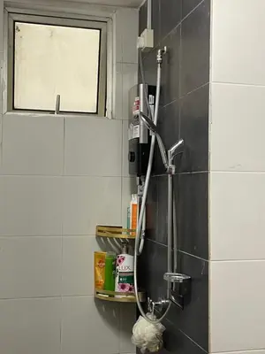 a shower in the corner of a bathroom at Azmaya homestay in Kuala Lumpur