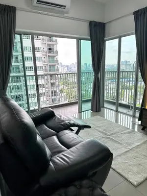 a living room with a leather couch and large windows at Razak City Residences in Kuala Lumpur