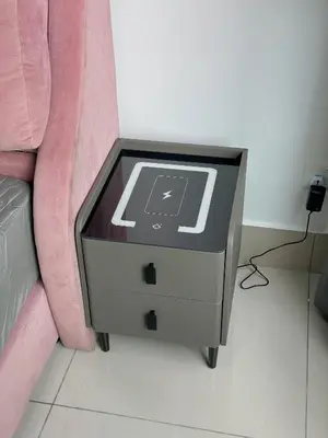 a side table with a computer on it next to a couch at Razak City Residences in Kuala Lumpur