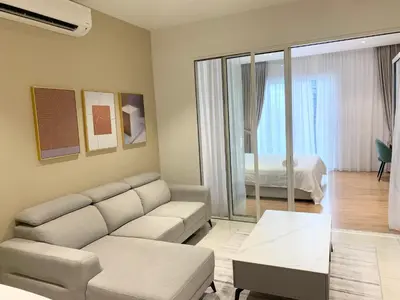 a living room with a couch and a bedroom at Quill Residences Service Suites By BR in Kuala Lumpur
