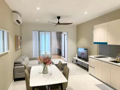 a kitchen and living room with a table and a couch at Quill Residences Service Suites By BR in Kuala Lumpur