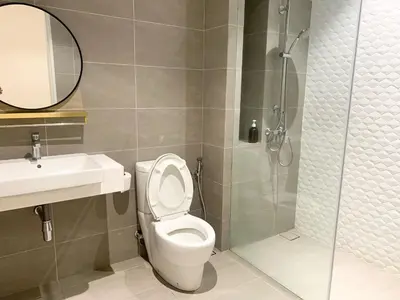 a bathroom with a toilet and a sink and a shower at Quill Residences Service Suites By BR in Kuala Lumpur