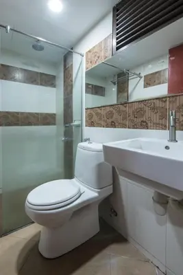 a bathroom with a white toilet and a sink at Hotel grand orchard in Kuala Lumpur