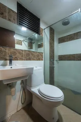 a bathroom with a toilet and a sink and a shower at Hotel grand orchard in Kuala Lumpur