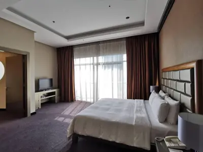 a hotel room with a large bed and a television at St Giles Gardens Residences Kuala Lumpur in Kuala Lumpur