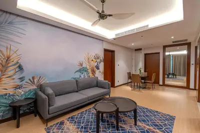 a living room with a couch and a table and chairs at St Giles Gardens Residences Kuala Lumpur in Kuala Lumpur