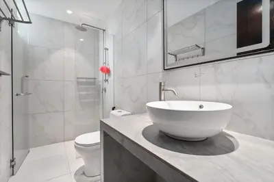 a white bathroom with a sink and a toilet at Retreat In The Heart of KLCC, The Corinthians in Kuala Lumpur