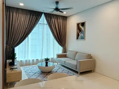 a living room with a couch and a large window at Soho Suites KLCC by Minsha Homes in Kuala Lumpur