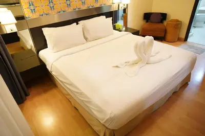 a large bed with white sheets and towels on it at The Luxe stay Bukit Bintang in Kuala Lumpur