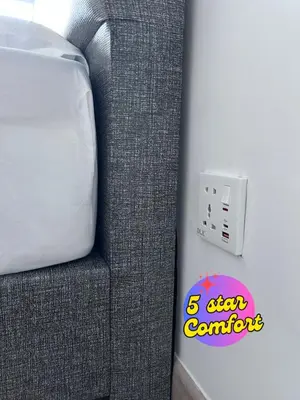 a bedroom with a bed and a sticker on the wall at 5 Star Comfort Riveria City KL Sentral 2pax Infinity pool in Kuala Lumpur