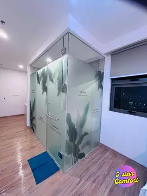 a room with a glass partition with plants painted on it at 5 Star Comfort Riveria City KL Sentral 2pax Infinity pool in Kuala Lumpur
