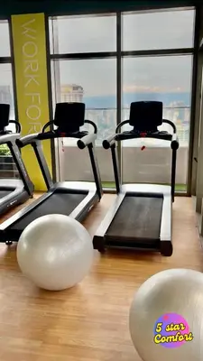 a gym with three cardio machines in a room at 5 Star Comfort Riveria City KL Sentral 2pax Infinity pool in Kuala Lumpur