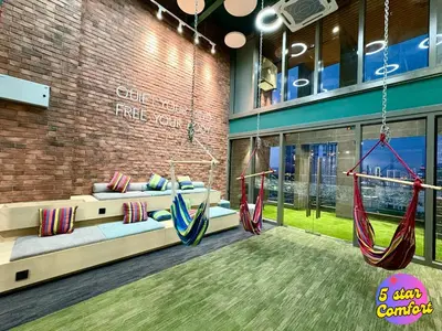 a room with two hammocks in a building at 5 Star Comfort Riveria City KL Sentral 2pax Infinity pool in Kuala Lumpur