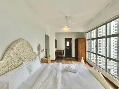 a bedroom with a large bed and a large window at 3 bedroom apt L21 in kl sentral with city view in Kuala Lumpur