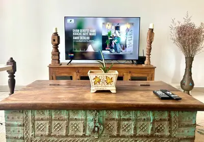 a living room with a tv and a coffee table at 3 bedroom apt L21 in kl sentral with city view in Kuala Lumpur