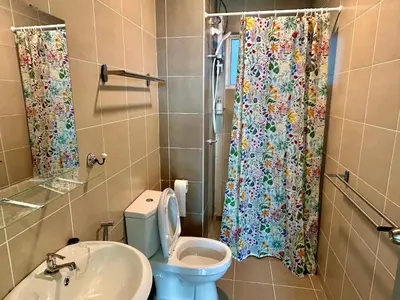 a bathroom with a blue toilet and a shower curtain at 3 bedroom apt L26 at kl sentral with city view in Kuala Lumpur