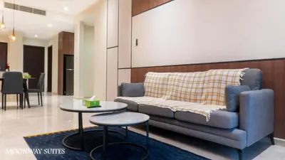 a living room with a couch and two tables at Harmony Luxury Suites At TM Persiaran Stonor KLCC in Kuala Lumpur