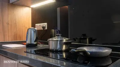 a kitchen counter with a pot on top of a stove at Harmony Luxury Suites At TM Persiaran Stonor KLCC in Kuala Lumpur