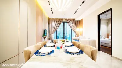 a dining room with a table and chairs and a bedroom at Harmony Luxury Suites At TM Persiaran Stonor KLCC in Kuala Lumpur
