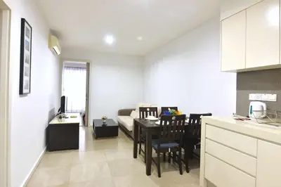 a kitchen and living room with a table and a couch at Modern 2BR Fairlane Retreat Steps from Lot 10 in Kuala Lumpur