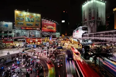 a busy city street at night with people and cars at Modern 2BR Fairlane Retreat Steps from Lot 10 in Kuala Lumpur