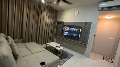a living room with a couch and a flat screen tv at Datum Jelatek Superb Suite KL By LH in Kuala Lumpur