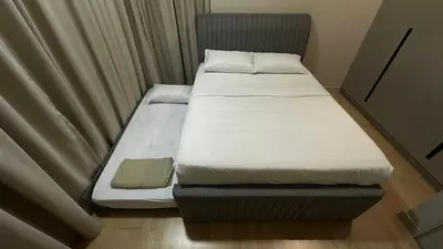 a small bed in a small room with curtains at Datum Jelatek Superb Suite KL By LH in Kuala Lumpur