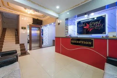 a lobby with a hotel grand ovation sign on the wall at Hotel grand orchard in Kuala Lumpur