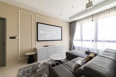 a living room with a couch and a flat screen tv at Novo Ampang KL near Gleneagles by Sleepy Bear in Kuala Lumpur