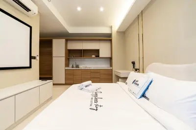 a bedroom with a white bed and a projection screen at Novo Ampang KL near Gleneagles by Sleepy Bear in Kuala Lumpur
