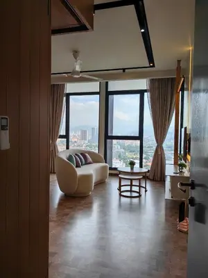 a living room with a couch and large windows at EXPRESSIONZ DESIGNER SUITES Host By AURORA PREMIUM STAY in Kuala Lumpur
