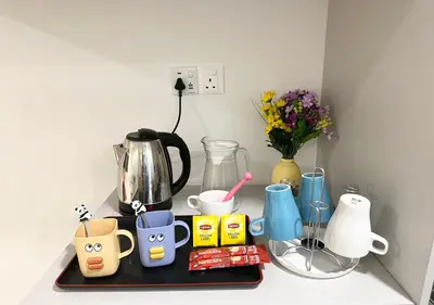 a tray with cups and other items on a counter at KL Sentral Monorail Infinity Sky Pool Family Suites -The RIV in Kuala Lumpur