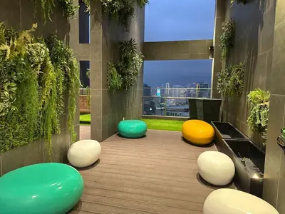 a room with three different colored ottomans at KL Sentral Monorail Infinity Sky Pool Family Suites -The RIV in Kuala Lumpur