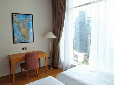 a hotel room with a desk and a window at KL Tower View 3room 2bath 1free parking KLCC in Kuala Lumpur