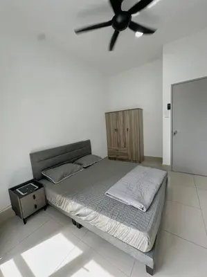 a bed in a room with a ceiling fan at Rc Residences in Kuala Lumpur