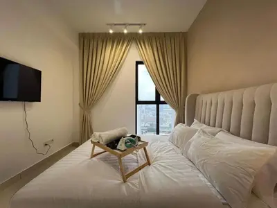 a bedroom with a large white bed with a window at Trion klcc view apartment near TRX in Kuala Lumpur