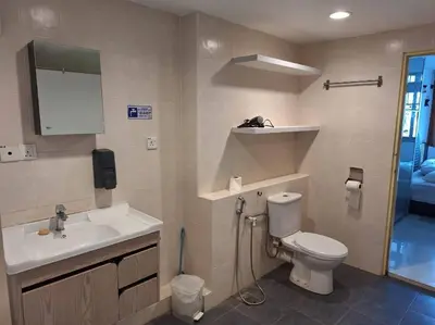 a bathroom with a white toilet and a sink at Fahrenheit, Stay in the Heart of KL, 15 pax in Kuala Lumpur
