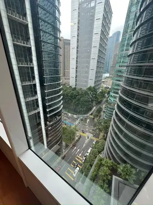a view from a window of a city with tall buildings at Premium Living Sky Suites - Twin Towers KLCC 2-min walk in Kuala Lumpur