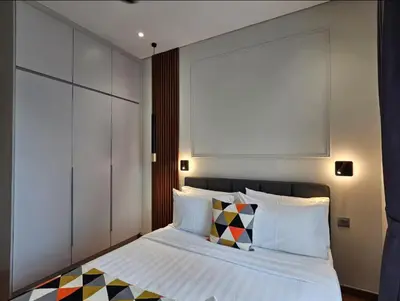 a bedroom with a bed with white sheets and pillows at Premium Living Sky Suites - Twin Towers KLCC 2-min walk in Kuala Lumpur