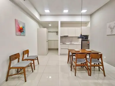 a kitchen with a table and chairs and a refrigerator at Chamber Suite Klcc & KL Tower view in Kuala Lumpur