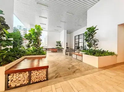 a large room with plants and benches in a building at Chamber Suite Klcc & KL Tower view in Kuala Lumpur