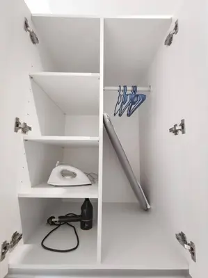a white cubicle with a baseball dugout with a bat at Chamber Suite Klcc & KL Tower view in Kuala Lumpur