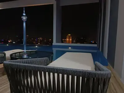 a balcony with a view of a city at night at COL 31B Modern Infinity Pool KLCC View in Kuala Lumpur