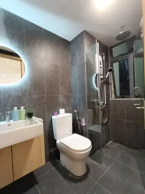 a bathroom with a shower and a toilet and a sink at COL 108A Modern KLCC Balcony View & Infinity Pool in Kuala Lumpur